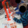 Children playing with the TIP Toy toolkit, a tangible programming device that allows them to create simple programmes by arranging plastic blocks in sequence
